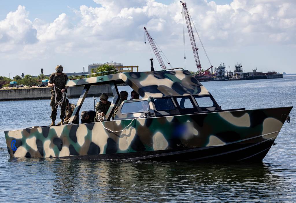 Northrop Grumman's Manta Ray unmanned underwater vehicle is seen during at-sea testing in 2024. A person can be seen in a boat behind it.