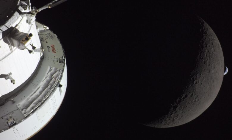 a white nasa and esa spacecraft with the moon and a crescent earth in the background