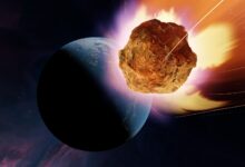 An illustration of a glowing rocky asteroid headed towards a blue planet in shadow.