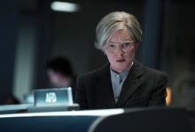 a woman in front of a mission control monitor