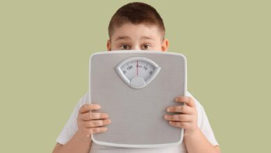 Childhood Obesity Overweight Boy Behind Scale