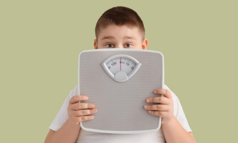 Childhood Obesity Overweight Boy Behind Scale