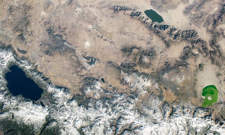 An astronaut photo showing three differently colored lakes in a triangle